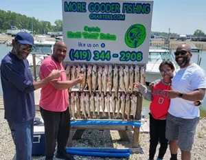 Happy group of anglers with their catch at More Gooder Fishing Charters.